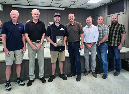 State Rep. Clint Owlett presents the Matthew E. Baker Community Servant Award to Mitch Gruver, owner of Papa’s Patties, in appreciation of his generosity in feeding thousands of people impacted by Hurricane Debby flooding last year. Pictured from left: former award recipient Ron Butler, former Rep. Matt Baker, Mitch Gruver, Rep. Clint Owlett, and Tioga County commissioners Shane Nickerson, Marc Rice and Sam VanLoon. 